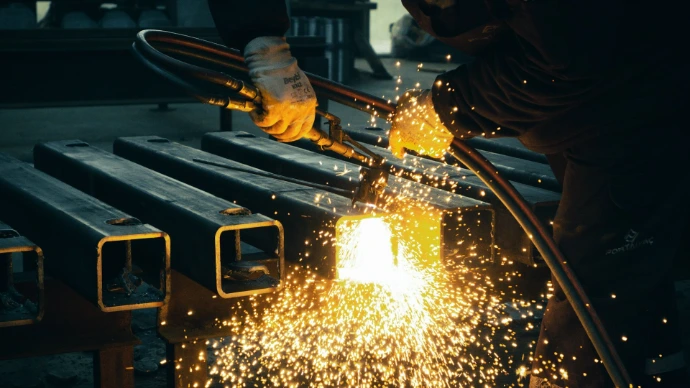 welder working on a piece of metal in a factory
